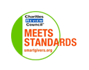 Logo indicating "Meets Standards" from the Charities Review Council, featuring a green background and text in orange and blue.
