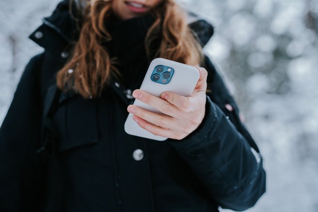 A teen girl scrolls on her phone.