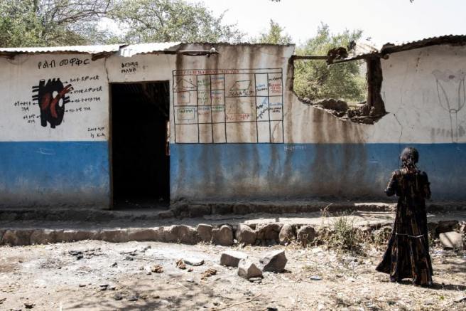Fourth-grade student Haimanot, 14, standing outside one of the classrooms that was bombed.